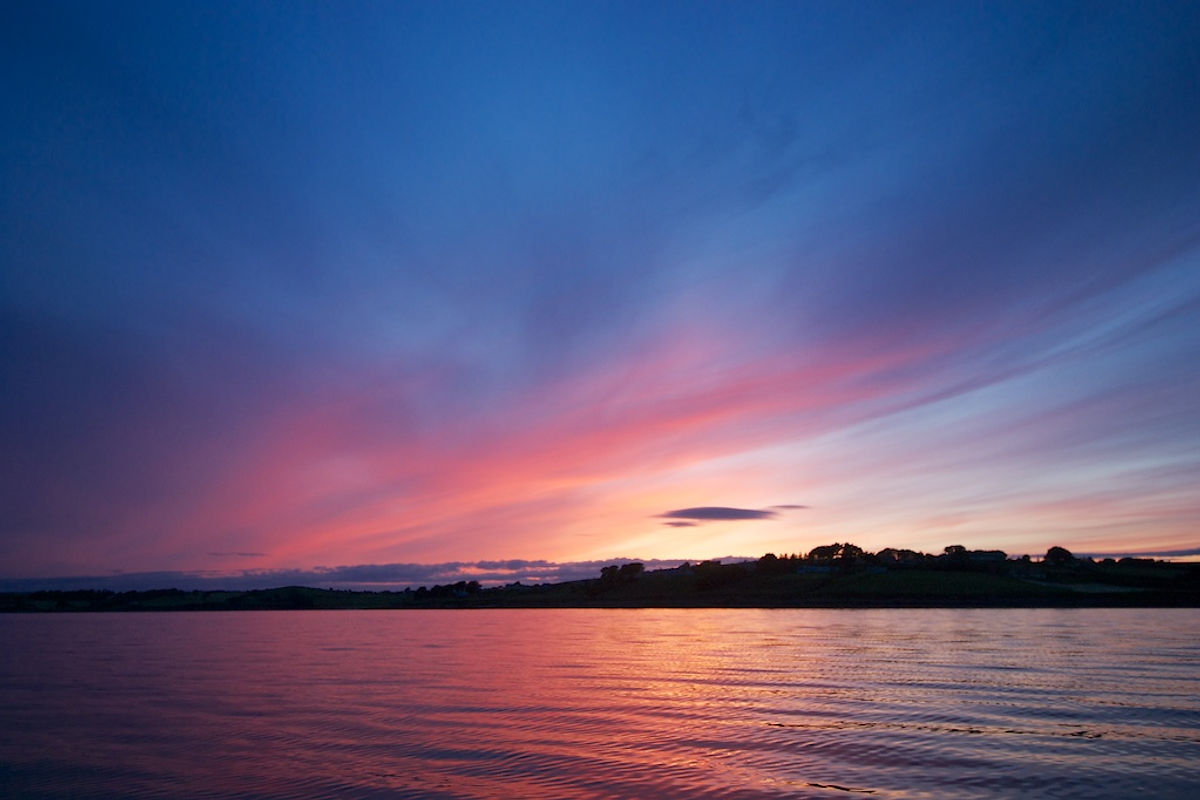 Pink and blue sunset over the water